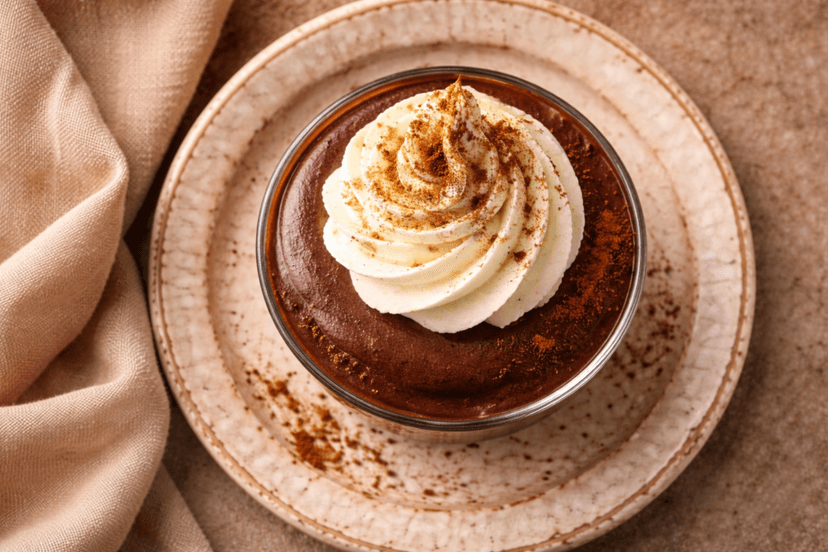 Creamy keto chocolate mousse in glass cup with coconut flakes, low carb dessert no bake